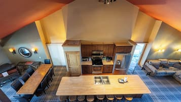 A spacious loft with a kitchen, dining area, and a cozy seating area.
