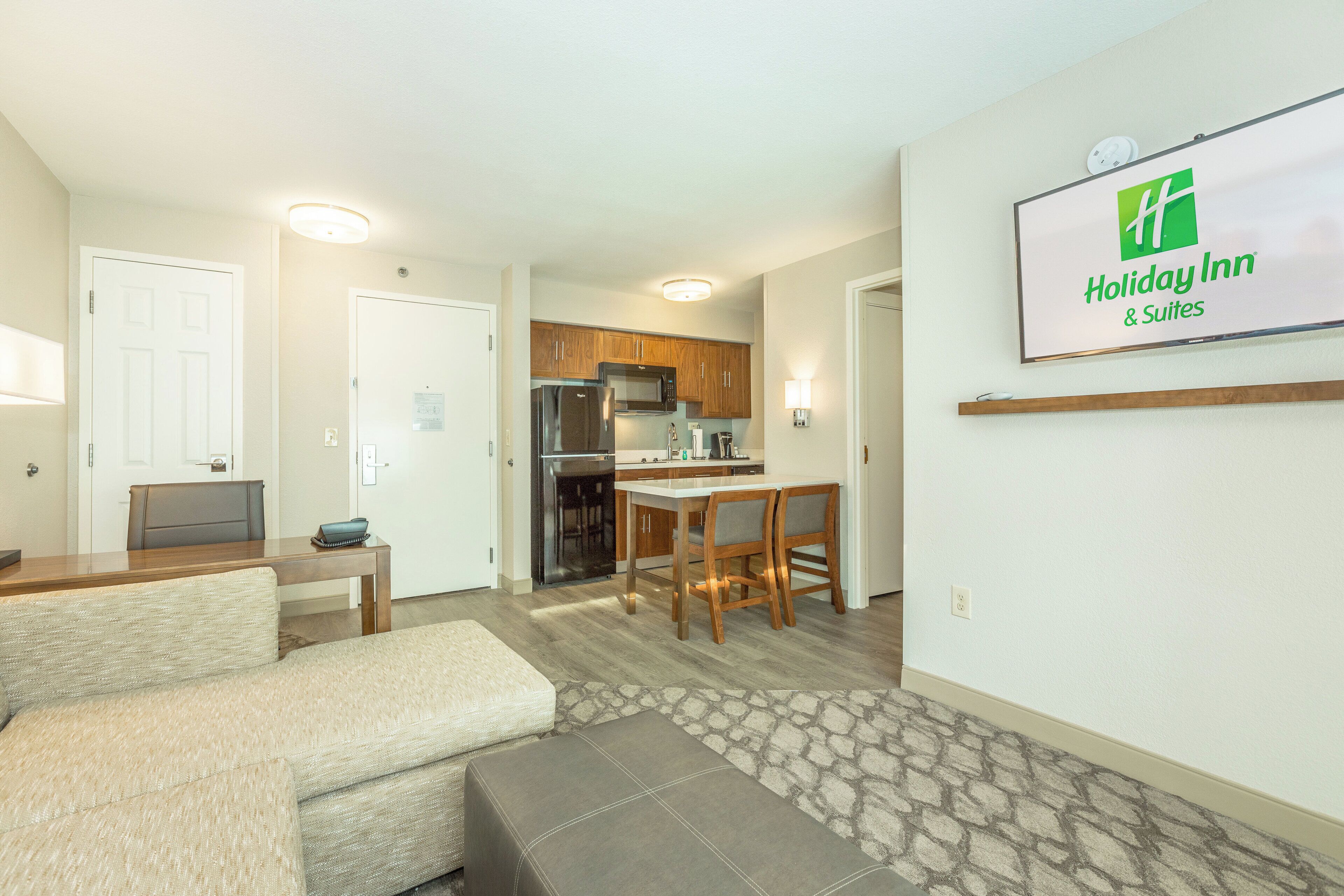 A compact living space with a kitchenette, a dining area, and a seating area.