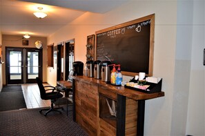Enjoy a freshly brewed cup at our coffee bar, where a variety of coffee-making equipment and a chalkboard menu await.
