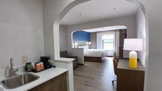 A hotel room with a kitchenette, a bed, a desk, and a bathroom. - Comfort Inn Marion near Downtown & Blue Ridge PKWY (Marion)