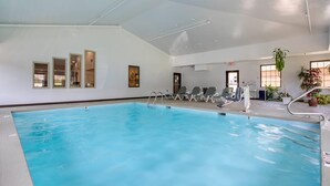 An indoor swimming pool with clear water, a diving board, and lounge chairs. - Comfort Inn Marion near Downtown & Blue Ridge PKWY (Marion)