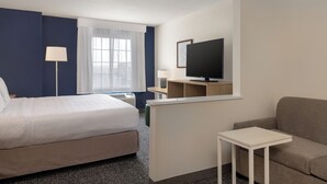 A hotel room with a bed, a TV, a desk, and a sofa. - Spark by Hilton El Paso University (El Paso)