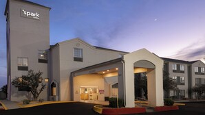 A hotel entrance with a 'Spark by Hilton' sign, a covered entryway, and a parking lot. - Spark by Hilton El Paso University (El Paso)
