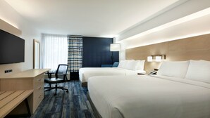 A hotel room with two beds, a desk, a chair, a TV, and a window with curtains. - Holiday Inn Express Williamsbrg Busch Gardens Area by IHG (Williamsburg)