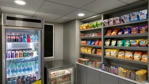 A vending machine stocked with various beverages and snacks. - Holiday Inn Express Williamsbrg Busch Gardens Area by IHG (Williamsburg)