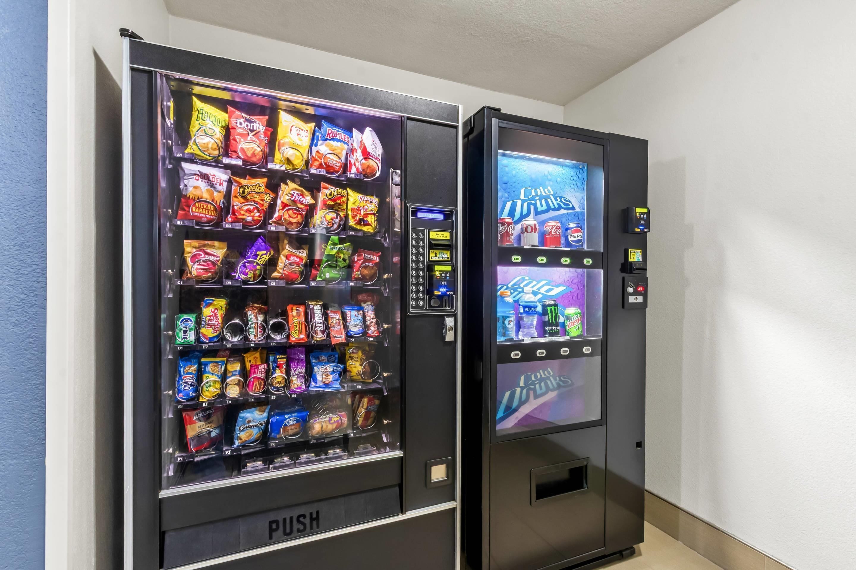 Two vending machines, one with snacks and the other with cold drinks.