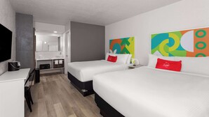 A hotel room with two beds, a desk, a chair, and a TV. - Travelodge by Wyndham Orlando Lake Buena Vista South (Kissimmee)