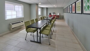 A conference room with a long table, chairs, a coffee station, and framed artwork on the walls. - Holiday Inn Express SANTA ROSA by IHG (Santa Rosa)