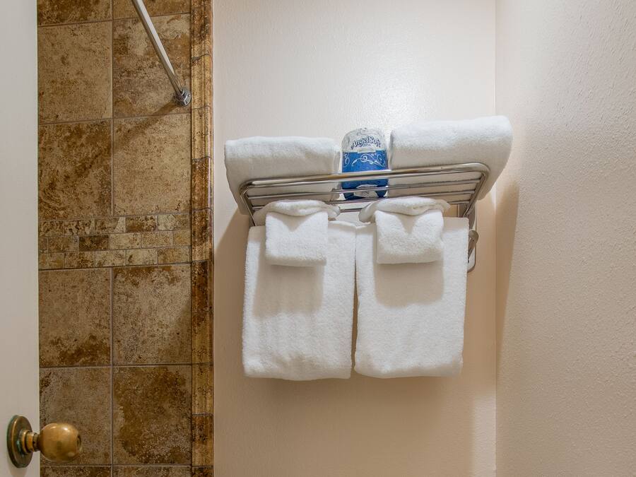 A bathroom with a toilet, a bathtub, and a shower.