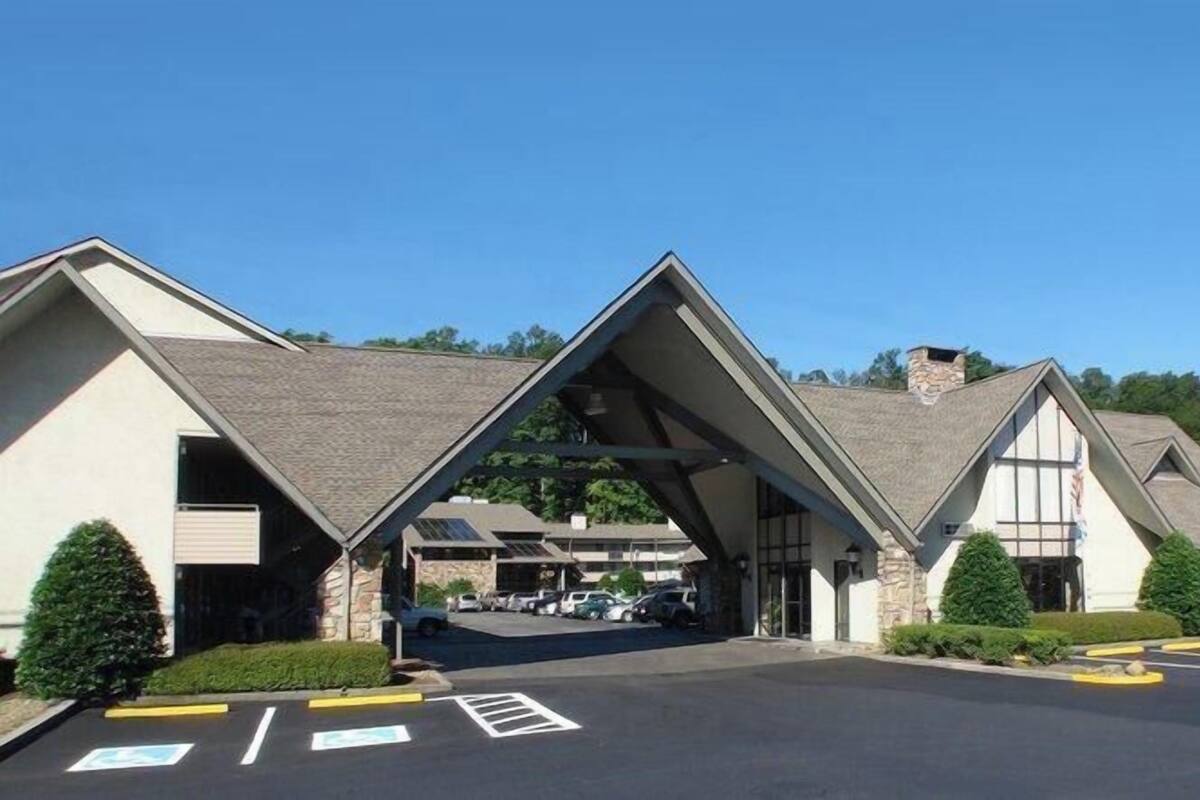 A TONY INN with a distinctive triangular roof structure and a parking lot in front.