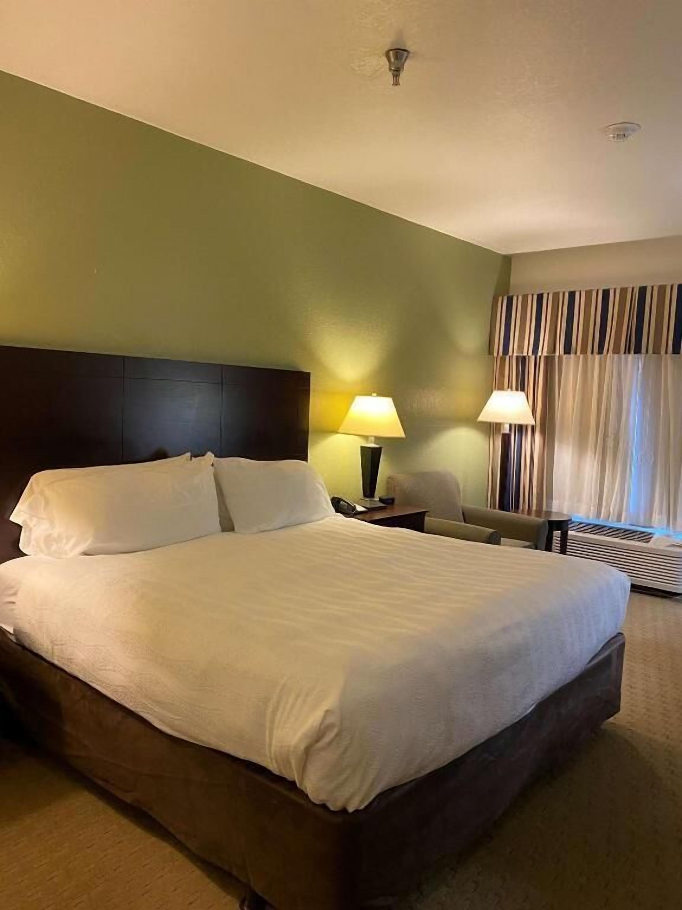 Premium bedding, desk, laptop workspace, blackout drapes