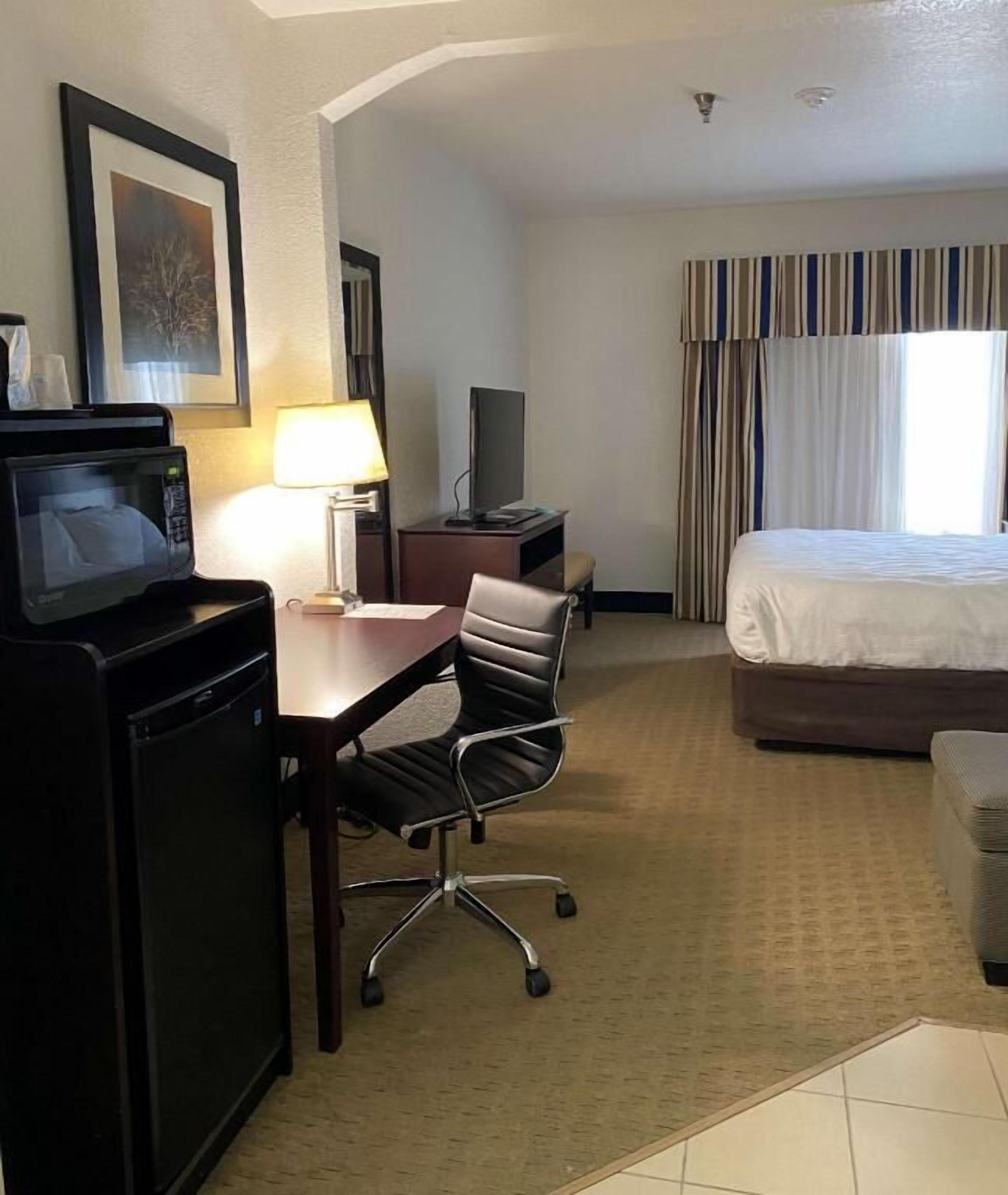 Premium bedding, desk, laptop workspace, blackout drapes