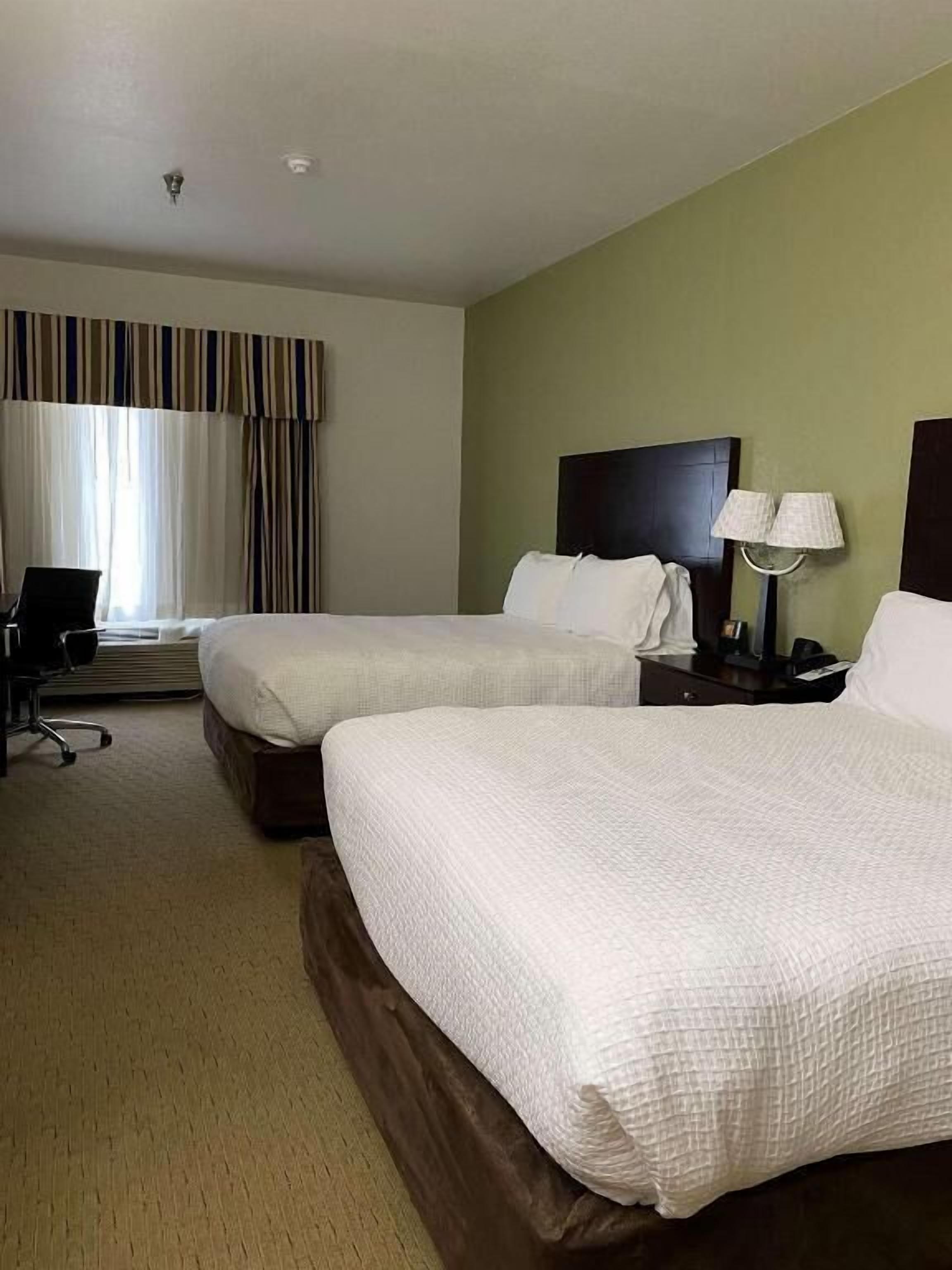Premium bedding, desk, laptop workspace, blackout drapes