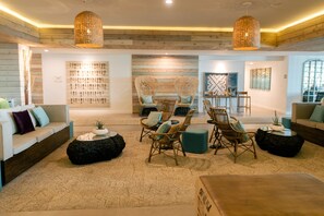 A spacious living area with a sofa, chairs, and a coffee table.