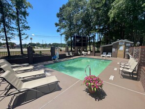 Relax by the pool surrounded by lush greenery and a tranquil atmosphere.
