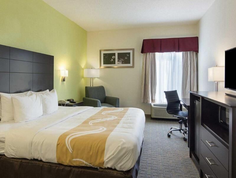 Premium bedding, desk, laptop workspace, blackout drapes