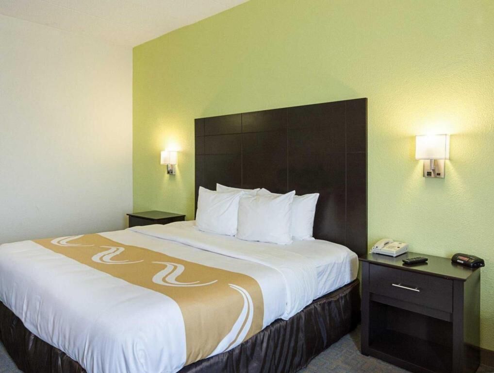 Premium bedding, desk, laptop workspace, blackout drapes