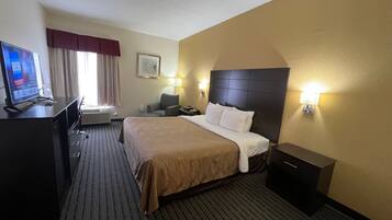 Premium bedding, desk, laptop workspace, blackout drapes