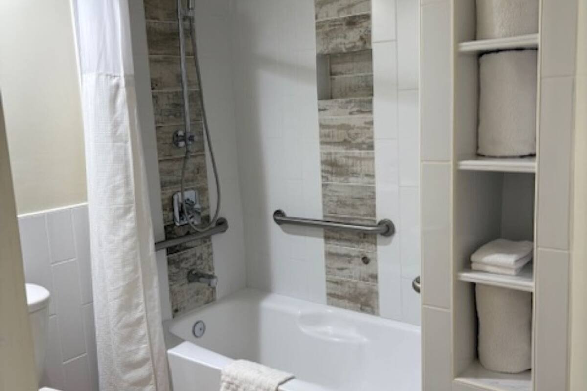 standard room, 1 king bed, accessible, refrigerator & microwave | bathroom | combined shower/bathtub, rainfall showerhead, free toiletries