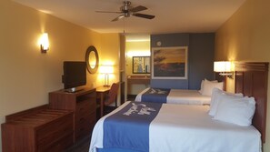 A hotel room with two beds, a desk, a television, and a ceiling fan. - Days Inn by Wyndham Trenton (Trenton)