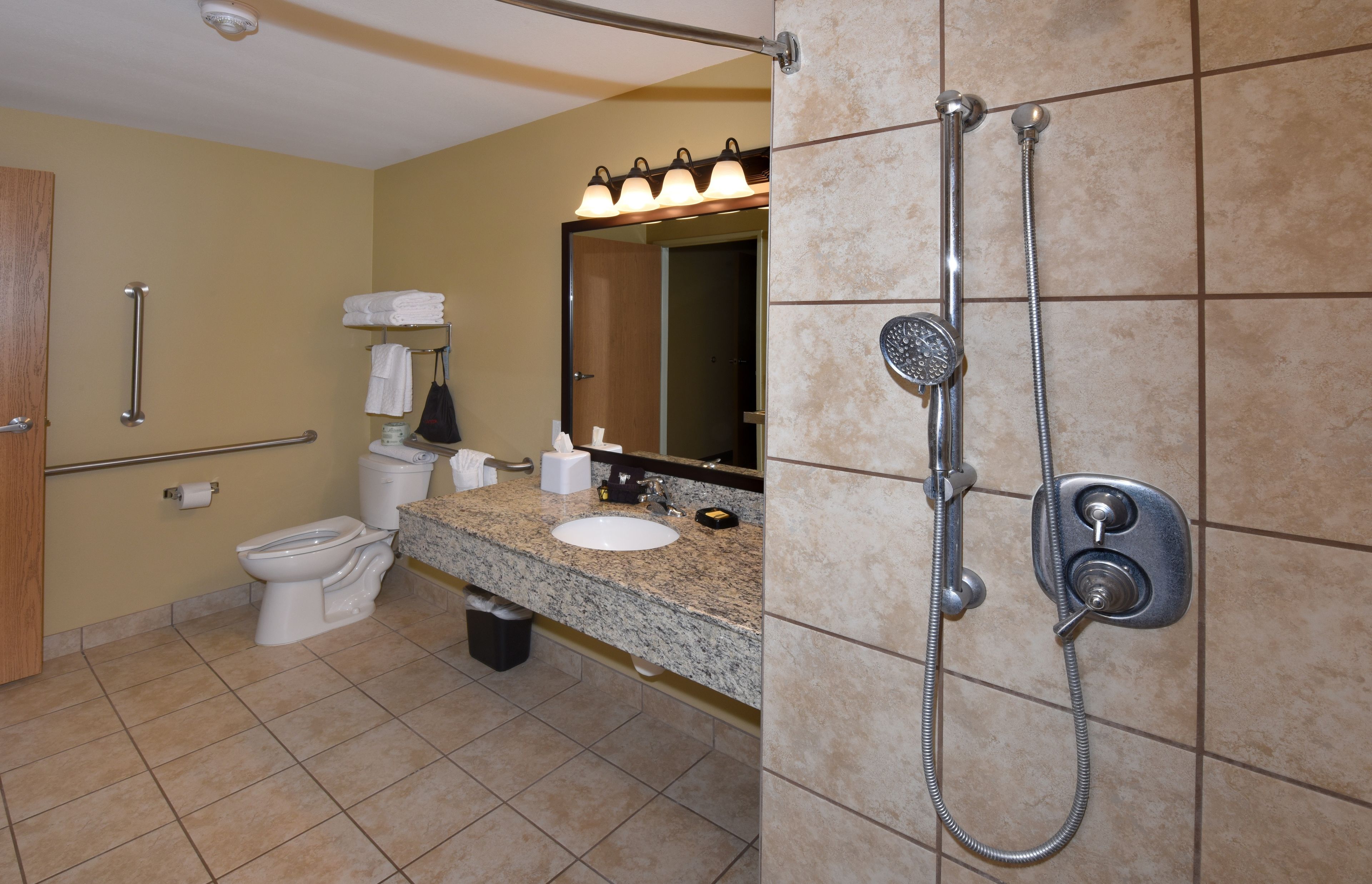 A bathroom with a toilet, sink, and shower.