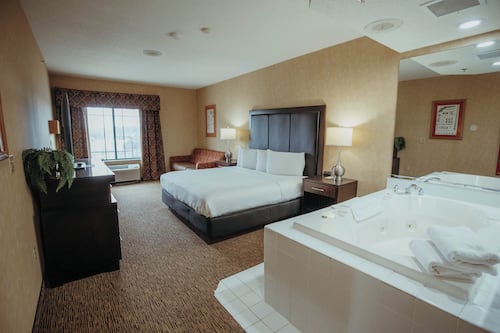 King Whirlpool Suite Accessible | Desk, laptop workspace, blackout curtains, iron/ironing board