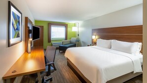 A hotel room with a bed, desk, chair, and a window with a view. - Holiday Inn Express Vermilion by IHG (Vermilion)