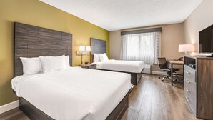 A hotel room with two beds, a desk, a chair, and a TV. - SureStay Plus Hotel by Best Western McGuire AFB Jackson (Cookstown)