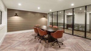 A conference room with a large table, six chairs, and a glass partition. - SureStay Plus Hotel by Best Western McGuire AFB Jackson (Cookstown)