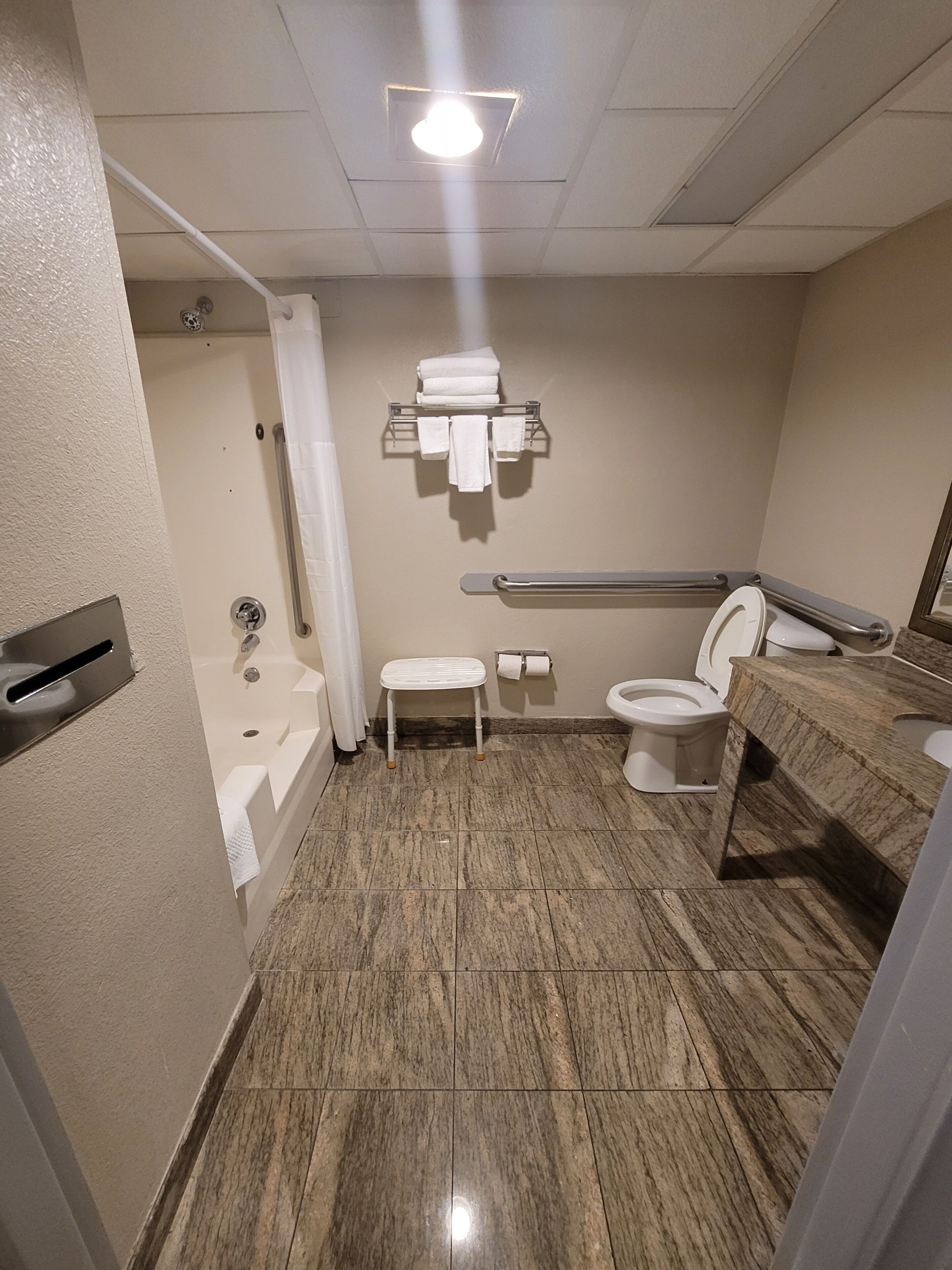 A bathroom with a bathtub, toilet, and sink.