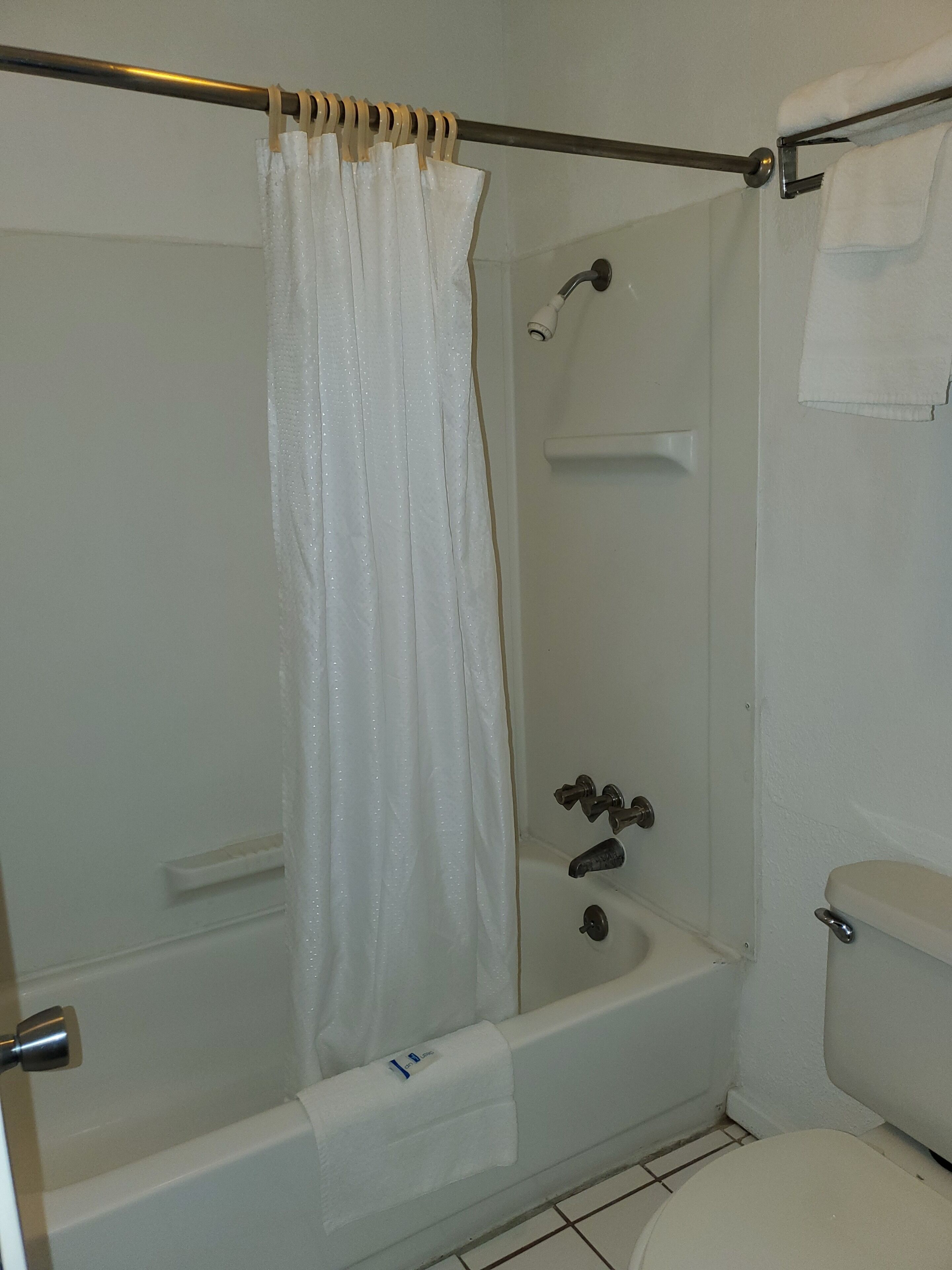 A bathroom with a bathtub, a shower, and a toilet.