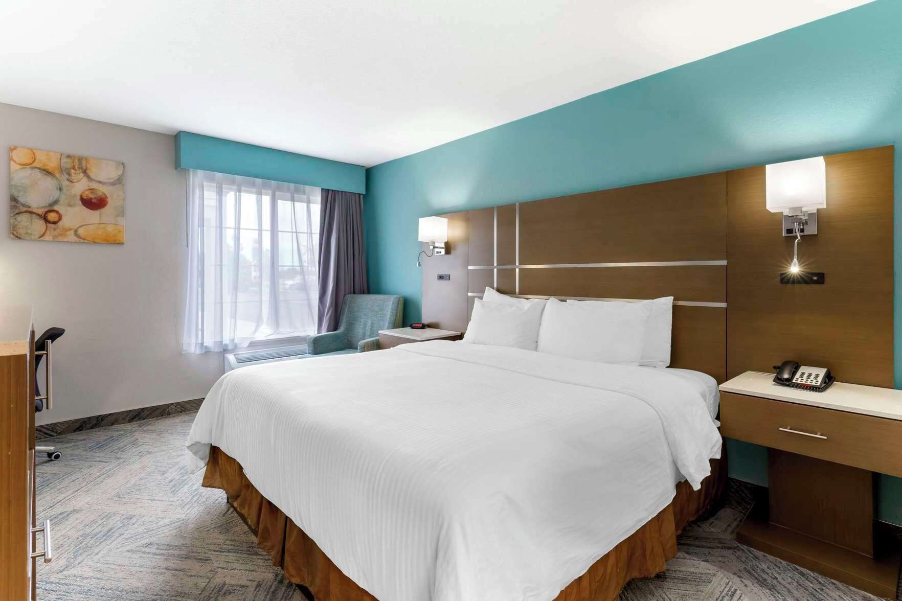 Desk, iron/ironing board, bed sheets