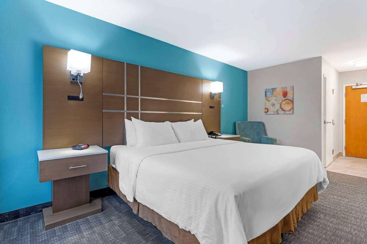 Desk, iron/ironing board, bed sheets