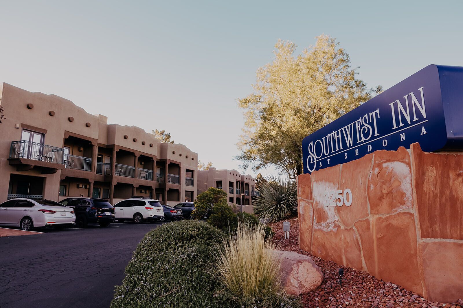 A Southwestern Inn building with a sign indicating the address 3250.