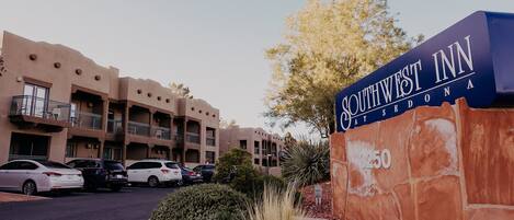 A Southwestern Inn building with a sign indicating the address 3250.