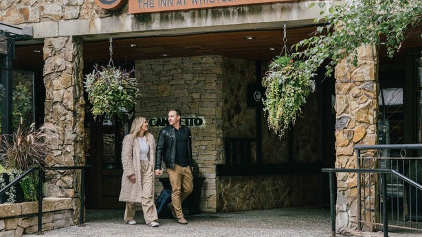 The Inn at Whistler Village with stone facade and a sign above the entrance. - Executive - The Inn at Whistler Village (Whistler)