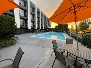 Outdoor pool, open 9 AM to 8:00 PM, pool umbrellas, pool loungers