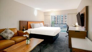 A hotel room with a bed, a sofa, a desk, and a TV. - The Vic, an Ascend Collection Hotel (Victoria)