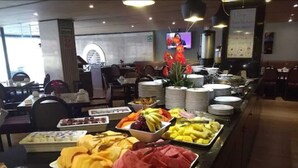 A buffet with various food items including fruits, meats, and desserts. - Hotel Metropol (Mexico City)