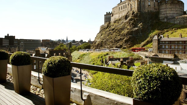 A historic castle on a hill overlooking a city.