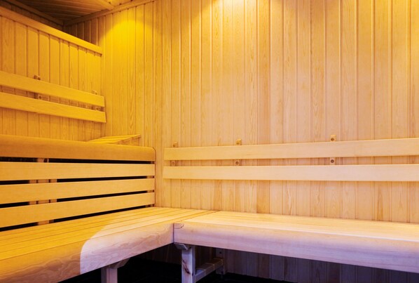 A wooden sauna with benches and a bench with a towel. - Apex Grassmarket Hotel (Edinburgh)