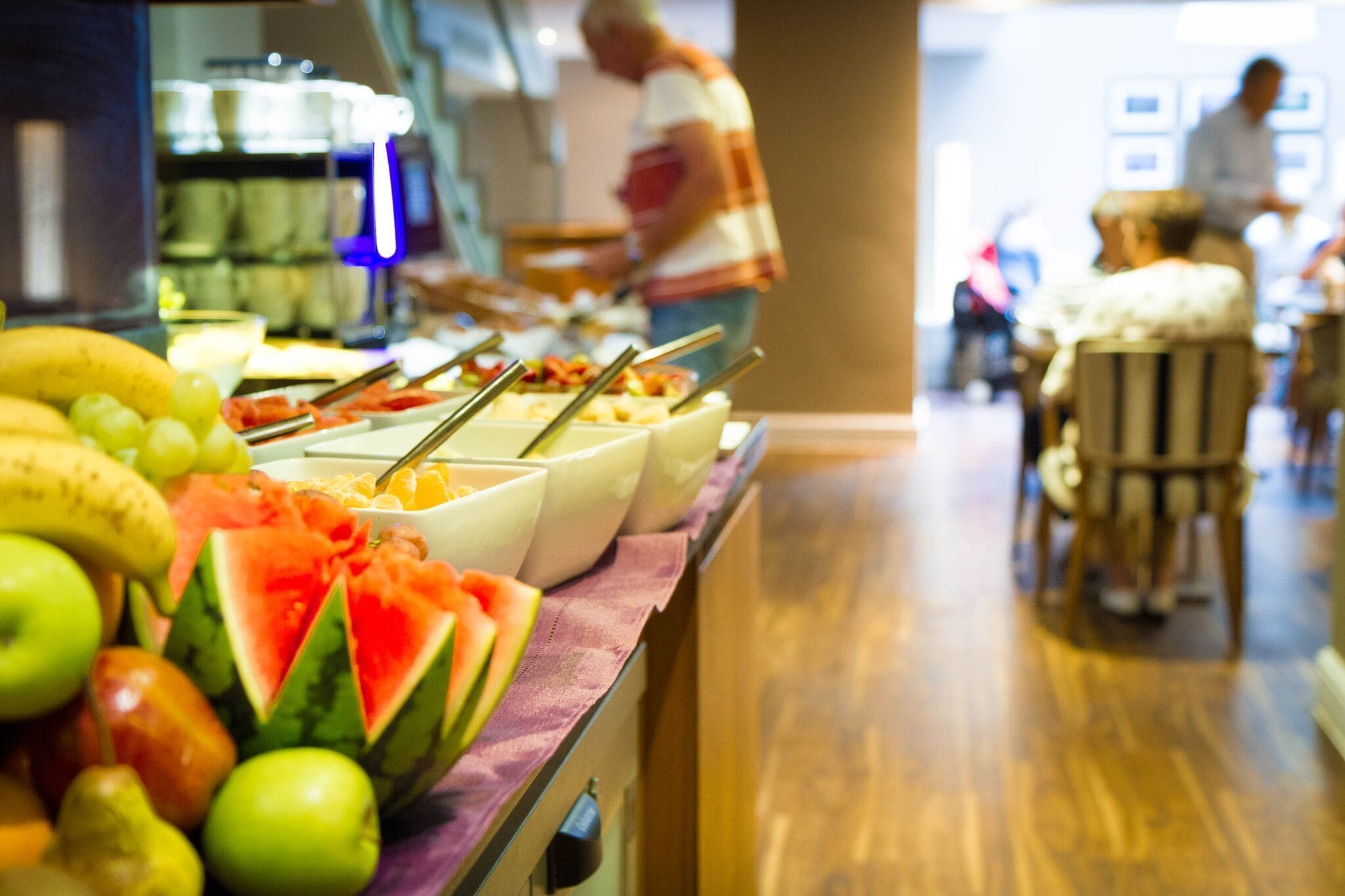 A buffet with various fruits and dishes.