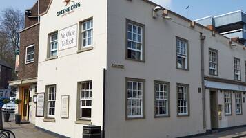 A building with a sign reading "Greene King Ye Olde Talbot" and a sign for "Main Meals" priced at ยฃ4.29.
