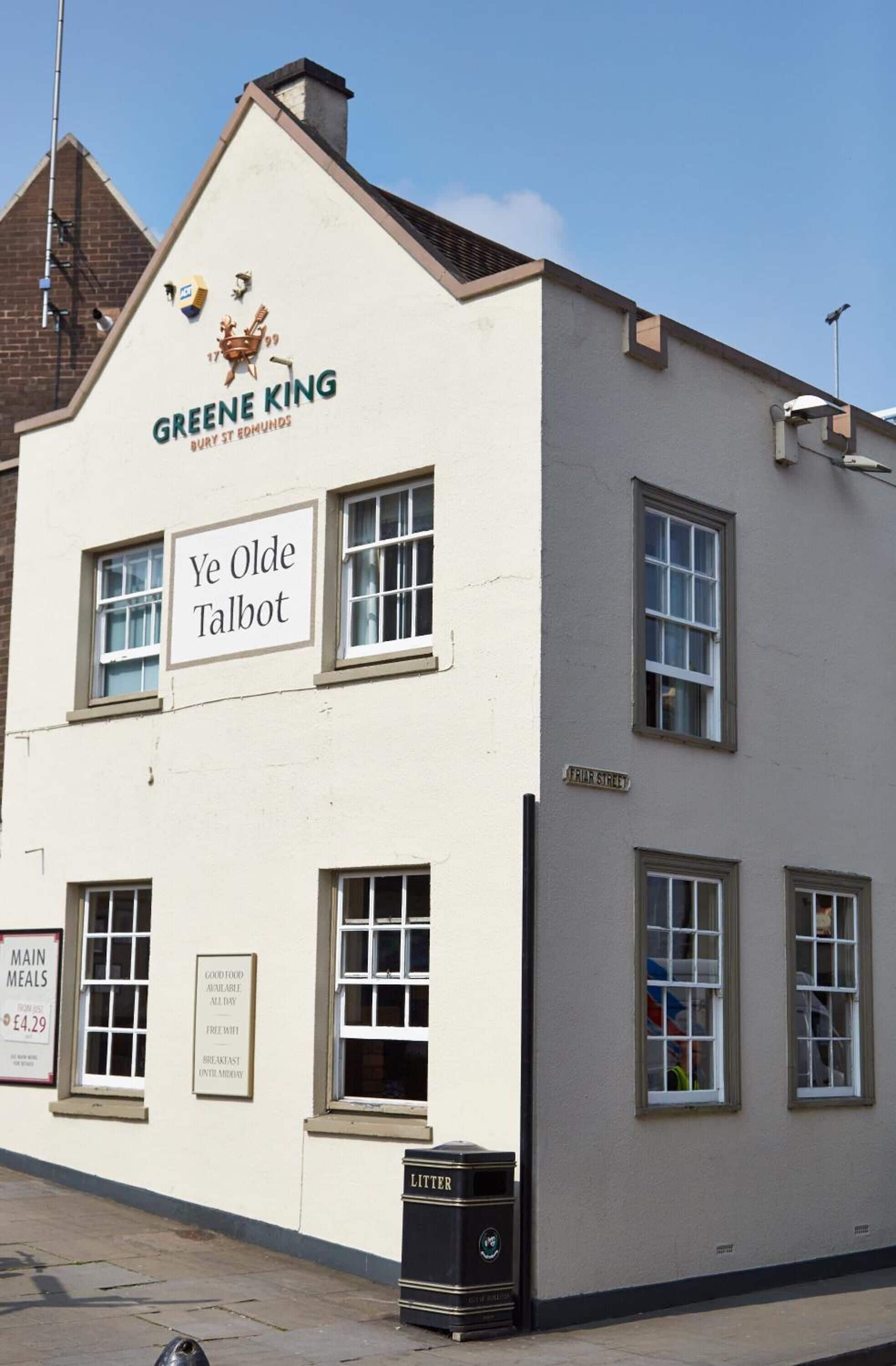 A building with a sign reading "GREENE KING BURY ST EMMONS" and "Ye Olde Talbot".