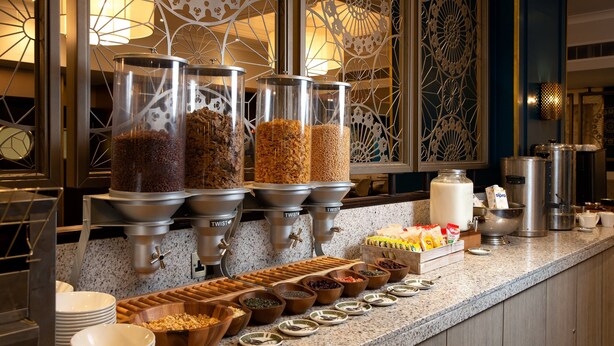 A buffet setup with various food items and containers. - Tavistock Hotel (London)