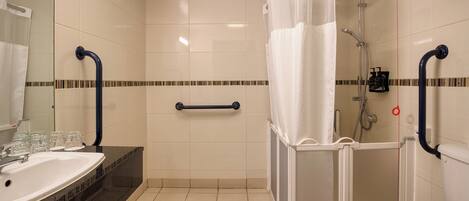 A bathroom with a shower, toilet, and sink.