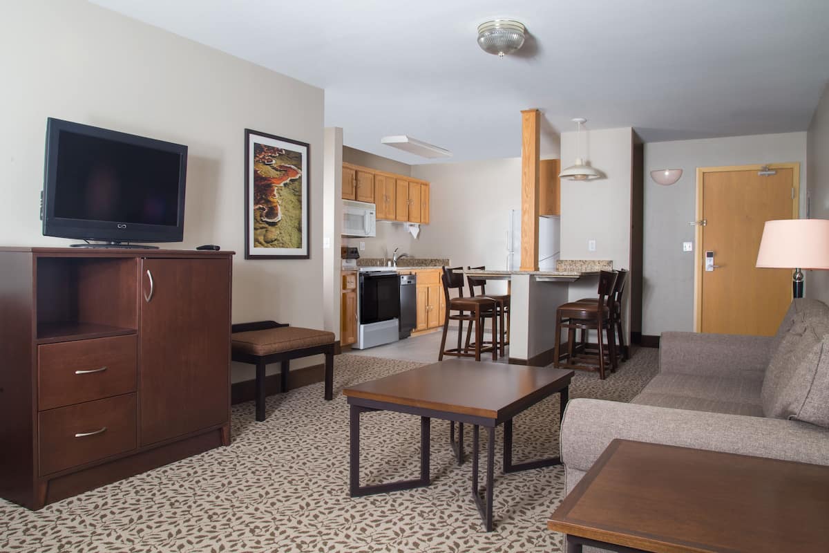 family suite, 2 queen beds | living area | tv