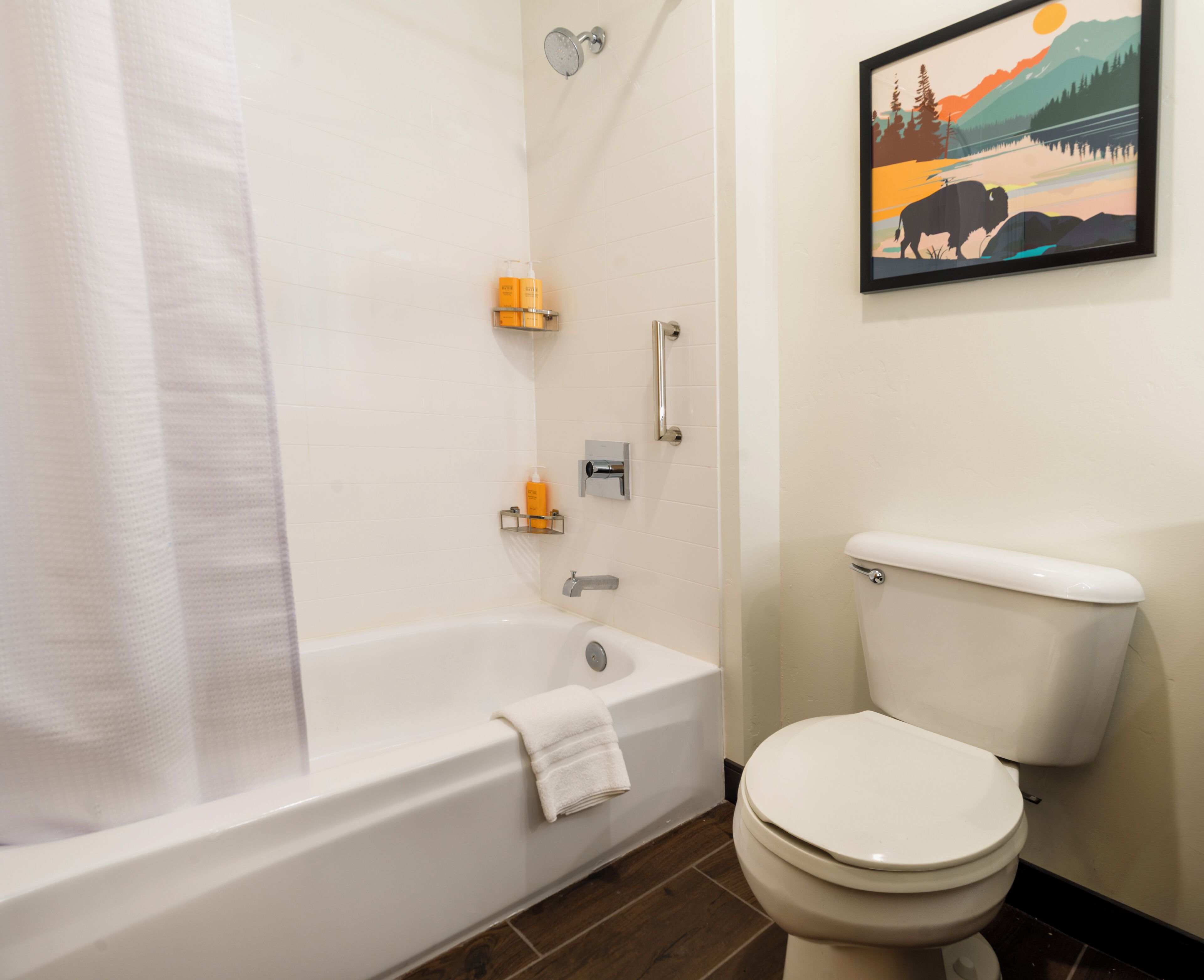 A bathroom with a bathtub, toilet, and a shower.