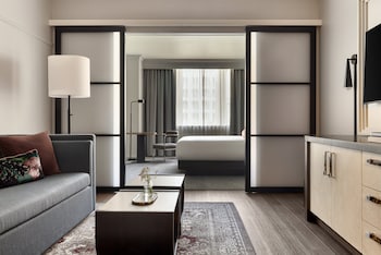 A bathroom with a marble sink, a mirror, and a plant. at Kimpton Hotel Monaco Seattle by IHG