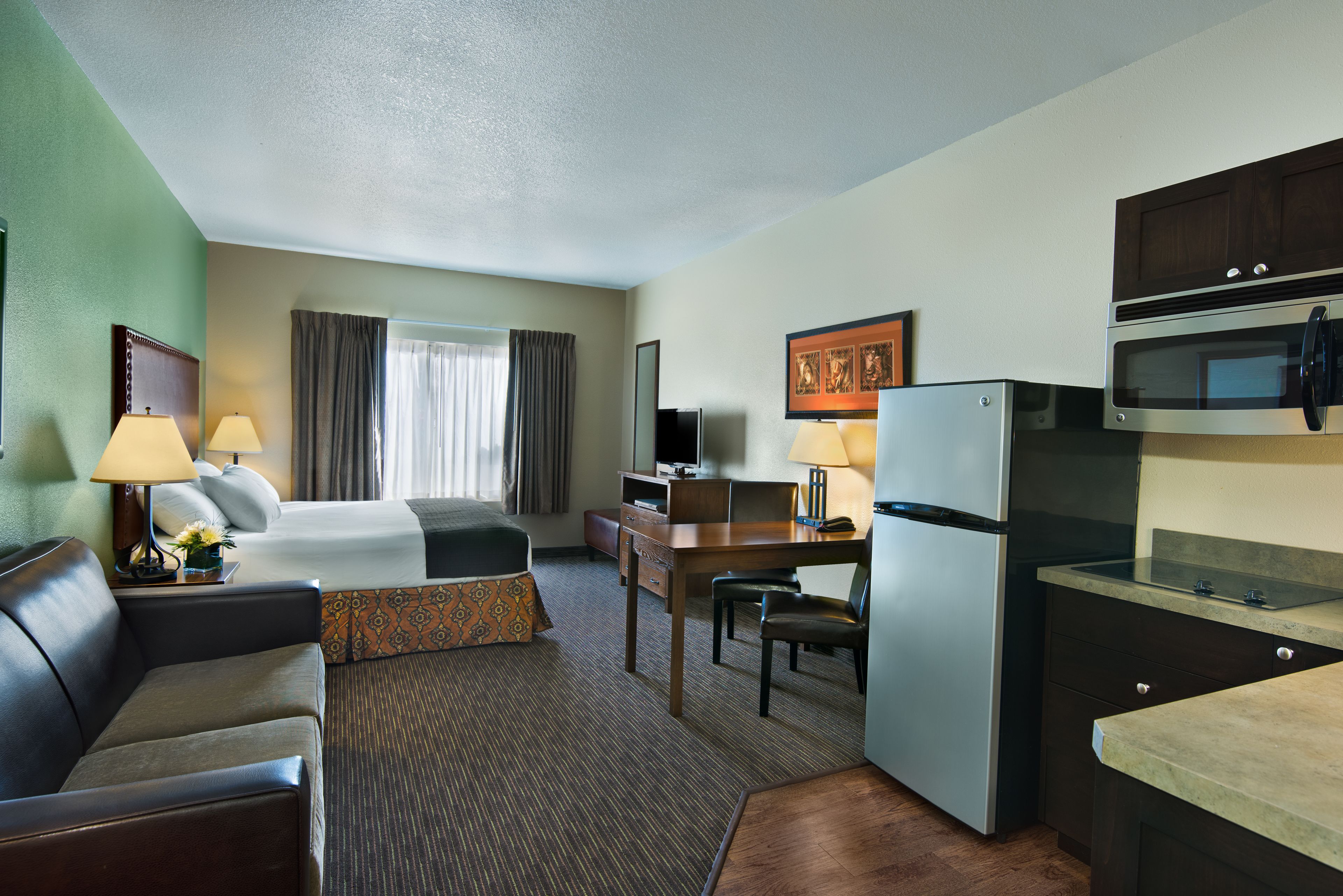 executive king suite | premium bedding, desk, laptop workspace, blackout curtains
